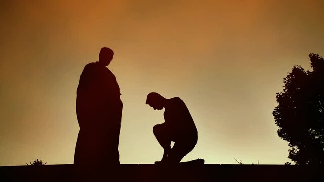 Man kneels before the priest