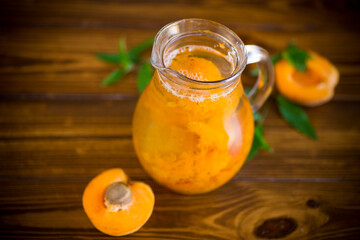 cold apricot compote in a glass decanter