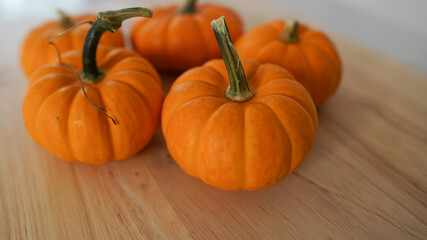 Mini pumpkins on a wooden countertop