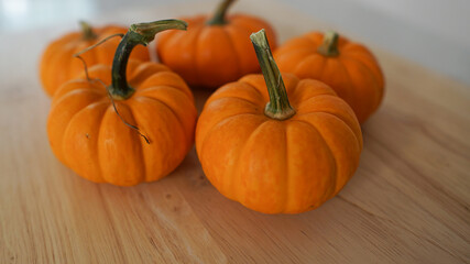 Mini pumpkins on a wooden countertop