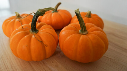 Mini pumpkins on a wooden countertop