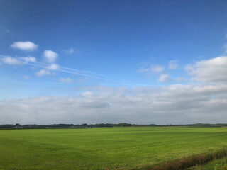 Fototapeta na wymiar Dutch polder landscapes. Havelte. Oude Vaart. Clouds. Blue sky. Drenthe Netherlands