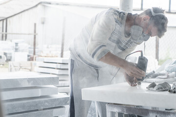 The master engraves the tombstone. Stone processing