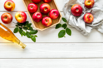 Top view of apple cider or vinegar - bottle with ripe fruits and leaves