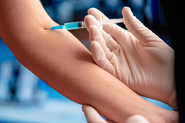 Close Up Of Vaccinating Patient With Syringe Injection. Vaccine and Medicine Trial. Prevention, Immunization.