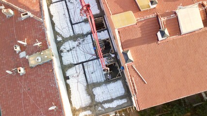 Aerial view of the building Construction in the city center. Pouring concrete using a crane.
