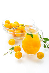 sweet cooked compote in a glass decanter of ripe yellow cherry plum