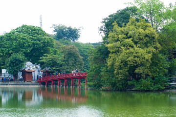 The Huc Bridge or Sun shine bridge at Hoan Kiem Lake, It`s a red wooden arch bridge.
