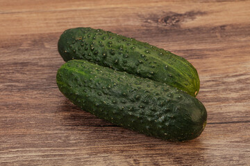 Green fresh cucumbers over background