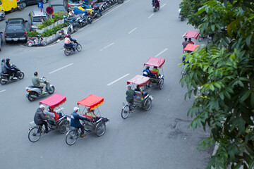 Traditional cyclo ride down the streets of Hanoi, Vietnam. The cyclo is a three-wheel bicycle taxi that appeared in Vietnam during the French colonial period.,September 19 2019