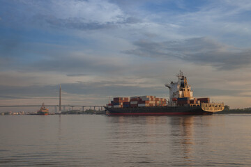 Fototapeta premium A shipping of maritime carrying container in boat on rever