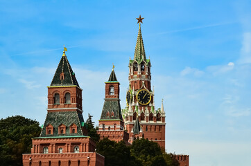 Fototapeta na wymiar Spasskaya Tower of Moscow Kremlin against background of blue sky. Famous chimes are the main clock of Russia. Sights of Russia, a historical building, symbol of the country.
