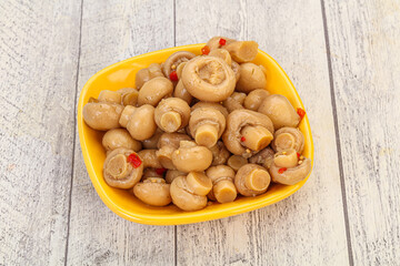 Pickled champignons in the bowl