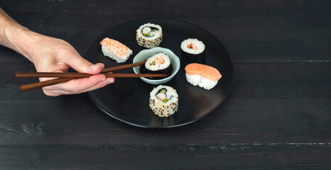 A hand holding sushi. Copy space. Food concept. Copy space.