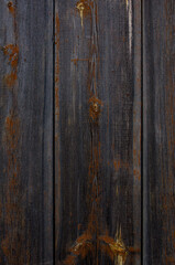 Old fence with remnants of brown paint