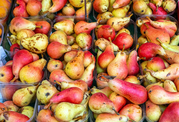 Red and yellow pears for sale at a market