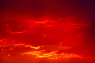 Red cloudy sky reflection the last rays of a sunset.