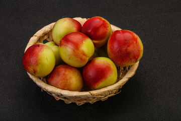 Sweet small nectarines in the basket