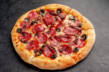 pizza pepperoni with salami sausages, mozzarella, olives, Provencal herbs, signature tomato sauce...