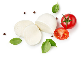 Pieces of mozzarella Buffalo cheese with basil leaves. Top view of sliced cheese with tomatoes...