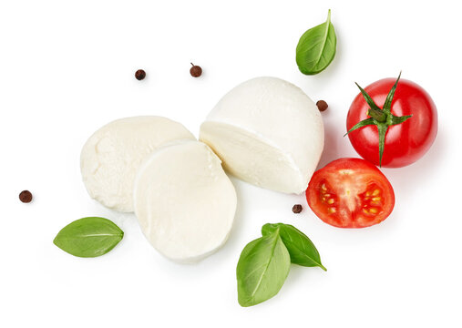 Pieces Of Mozzarella Buffalo Cheese With Basil Leaves. Top View Of Sliced Cheese With Tomatoes Isolated On White Background.