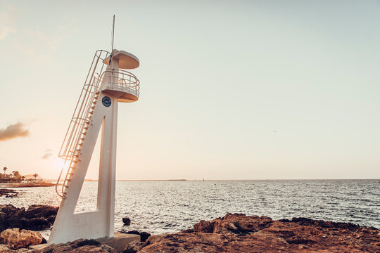 Empty lifeguard hut at sunset