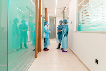 Female doctor talking to nurses in clinic