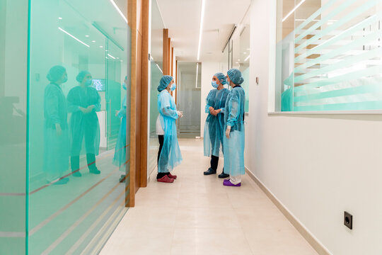 Female doctor talking to nurses in clinic