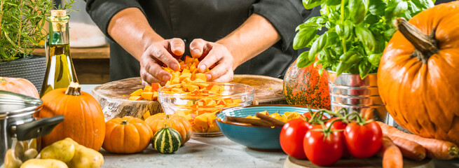 cropped shot of chef chopping ingredients for pumpkin soup