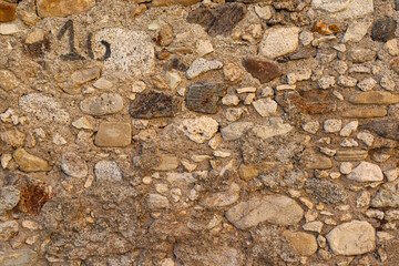 old wall texture made of stones, bricks and concrete. Old house and buildings