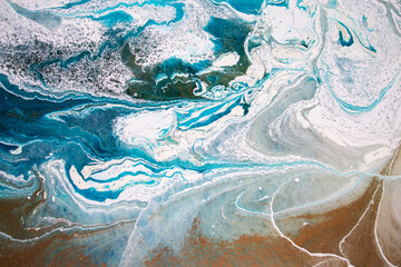 Abstraction. Ocean. Sea. Fluid art. Natural luxury. The style includes swirls of marble or ripples of agate. Very beautiful blue paint with the addition of gold powder
