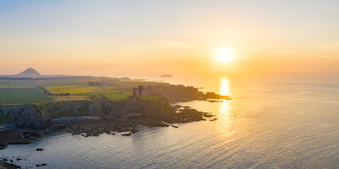 UK, Scotland, North Berwick, Aerial view of shore of Firth of Forth and ruins of Tantallon Castle at sunset