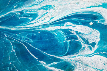 Abstraction. Ocean. Sea. Fluid art. Natural luxury. The style includes swirls of marble or ripples of agate. Very beautiful blue paint with the addition of gold powder