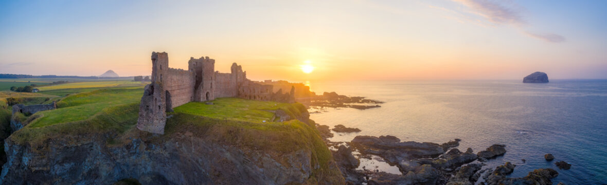 UK, Scotland, North Berwick, Aerial view of shore of Firth of Forth and ruins of Tantallon Castle at sunset
