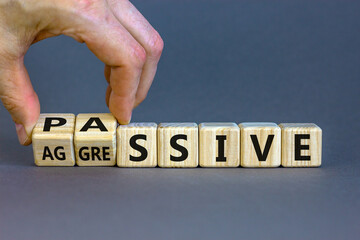 Hand turns cubes and changes the word 'passive' to 'aggressive', or vice versa. Business and...