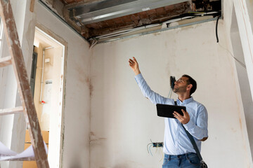 Architect using tablet in a house under construction