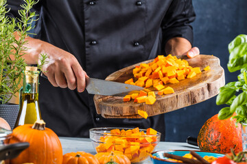 cropped shot of chef chopping ingredients for pumpkin soup