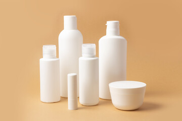 Set of white cosmetic bottles and jars with place to add text