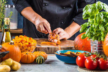 cropped shot of chef chopping ingredients for pumpkin soup