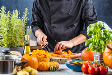 cropped shot of chef chopping ingredients for pumpkin soup