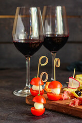 glass of wine and snack canapes cheese vegetables snack
plate serving size natural product portion top view place for text copy space food background rustic