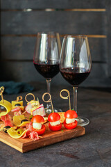 glass of wine and snack canapes cheese vegetables snack
plate serving size natural product portion top view place for text copy space food background rustic