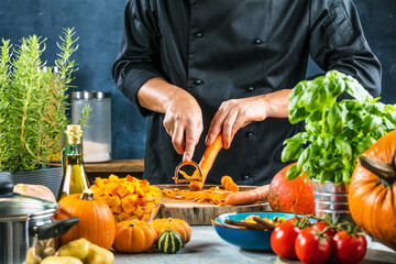 cropped shot of chef chopping ingredients for pumpkin soup