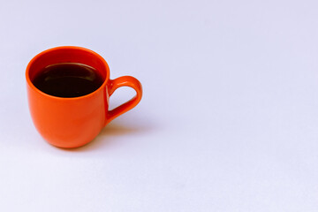 Orange color coffee cup on white color background