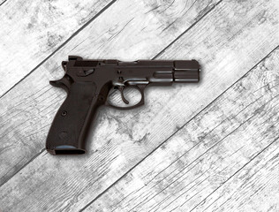 Semi automatic 9mm pistol  with 9mm rounds cartridges with a white wood background