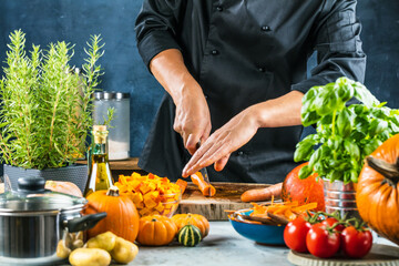 cropped shot of chef chopping ingredients for pumpkin soup
