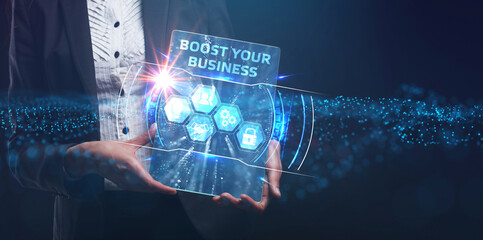 Business, Technology, Internet and network concept. Young businessman working on a virtual screen of the future and sees the inscription: Boost your business