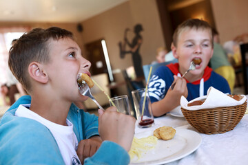Two brothers eating nuggets