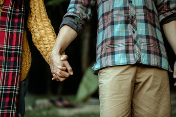 Young couple in love walking in the autumn park holding hands 
