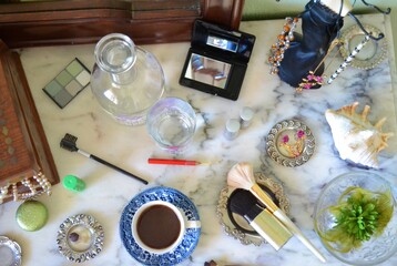 Aerial view of objects in a ladies' dresser on a marble table
